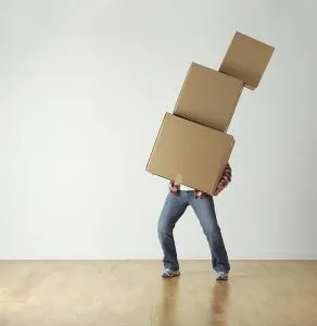 A man carrying three packingboxes