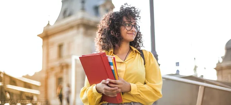 a girl holding a red book