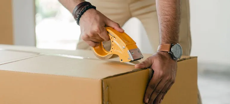 person sealing the box