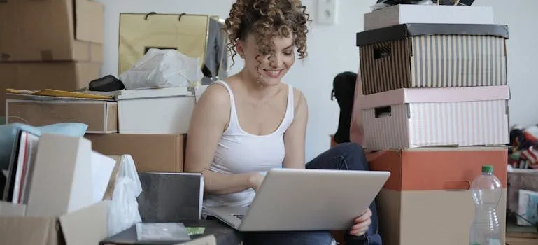 a woman looking at the laptop about moving into a smaller home