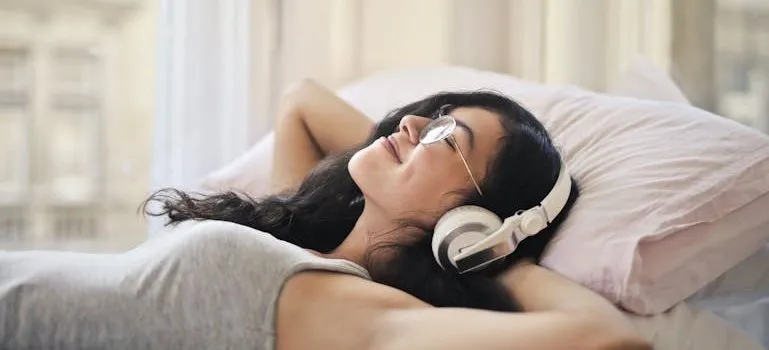 Woman in Gray Tank Top Lying on Bed