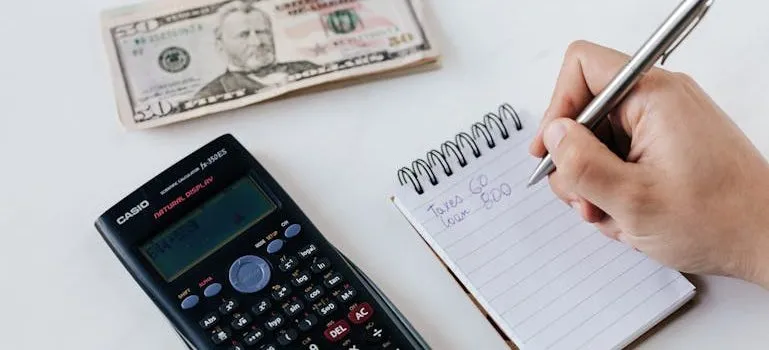 planning budget writing numbers in notebook