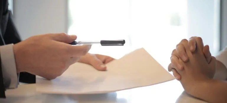 businessman giving contract to woman to sign