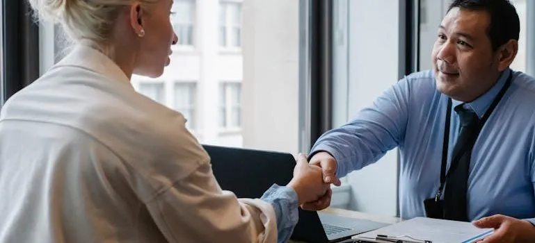 businessman shaking hand of applicant in office