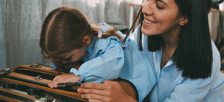 Woman and Daughter Packing Suitcase Together