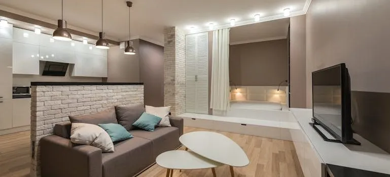 Spacious living room with couch and coffee table and TV