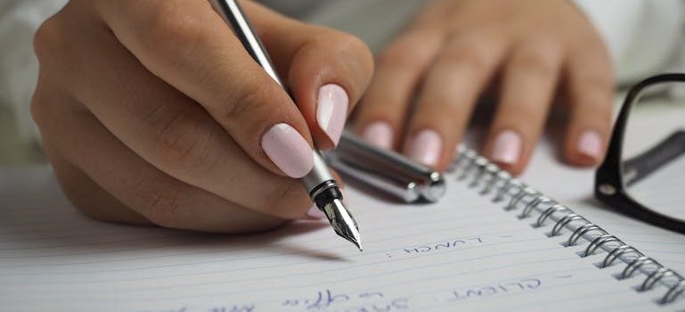 a woman writing the ultimate checklist for long-distance moves