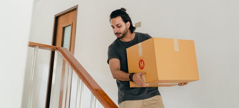 man carrying box down stairs