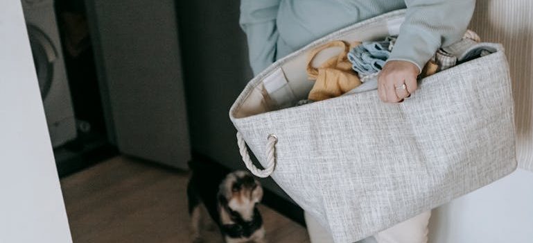 woman with bag of clothes near dog
