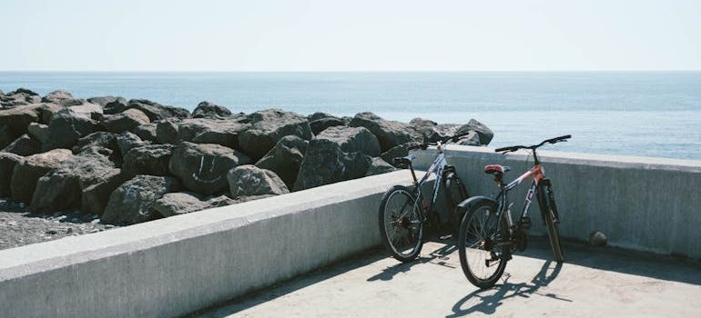 Two Bicycles Behind Gray Concrete Wall