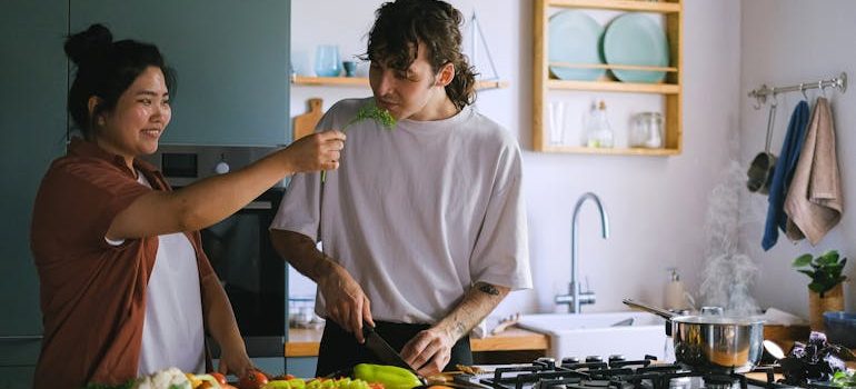 a couple cooking after moving in with a partner