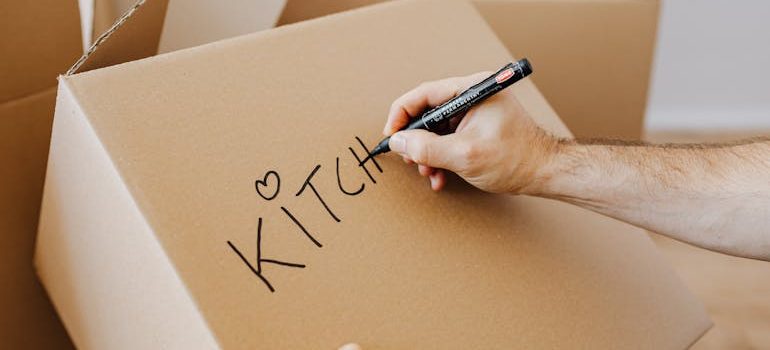 man signing carton moving boxes