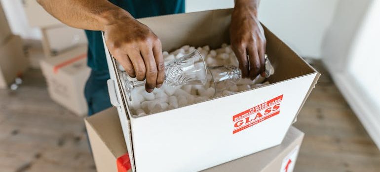 A Person Putting the Glasses in a Box