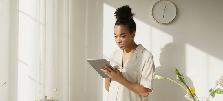 woman in White Shirt Using Silver Ipad