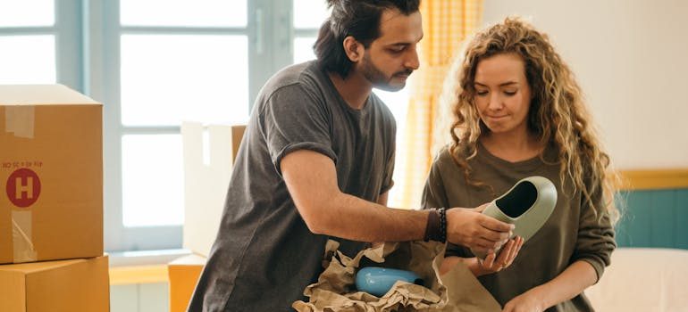 couple unpacking vase
