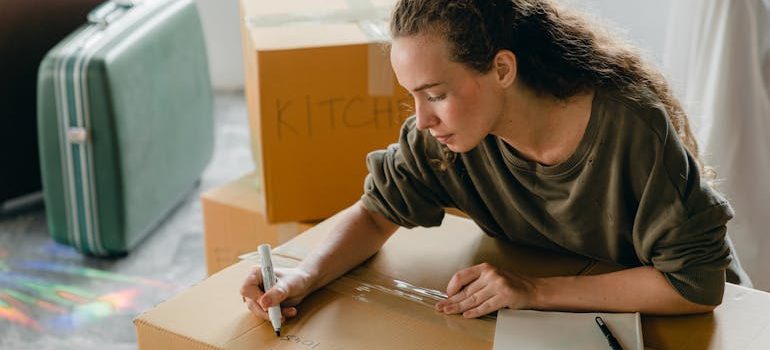 woman signing box before moving