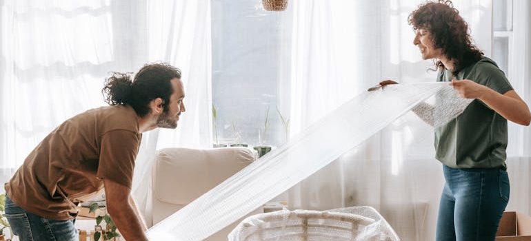 Couple Wrapping A Chair