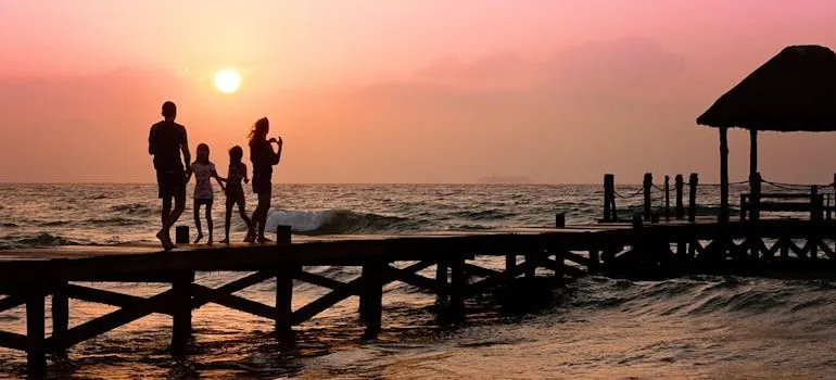 People Standing on Dock during Sunrise