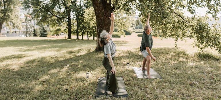 Man and Woman Doing Yoga Outdoors