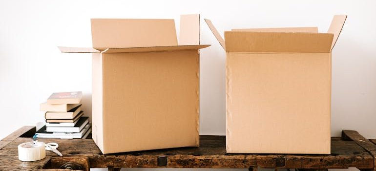 Carton boxes and stacked books on table