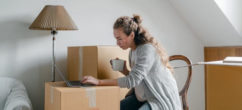 a woman reading about things to know before your big move