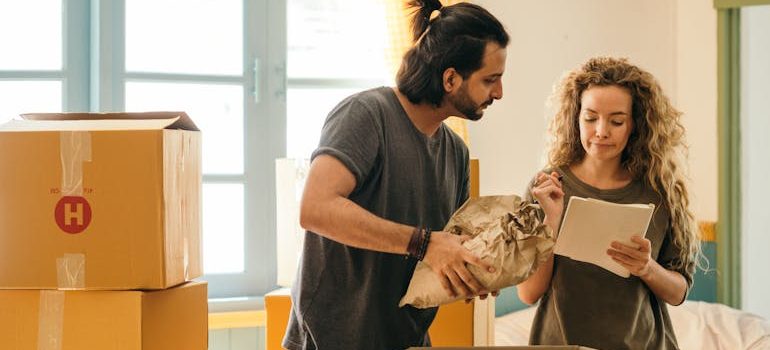 couple unpacking boxes in new home