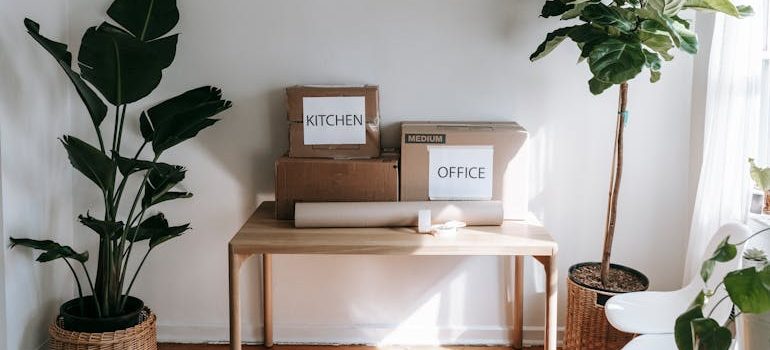 Brown Cardboard Boxes on Wooden Table