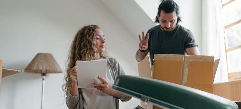 Focused couple packing stuff before moving out