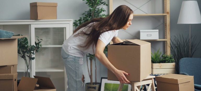 Woman with Boxes in House